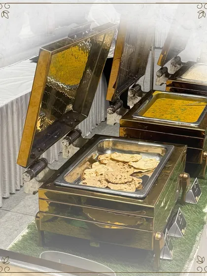 Our main course station, featuring hot rotis and a rich dal, served in beautiful brass-finished chafing dishes. We ensure our food is always served hot and fresh.