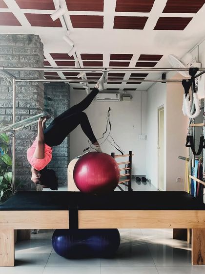 Connecting mind, body, and soul. This inverted hang on the Cadillac requires surrender and strength, allowing for deep spinal decompression.