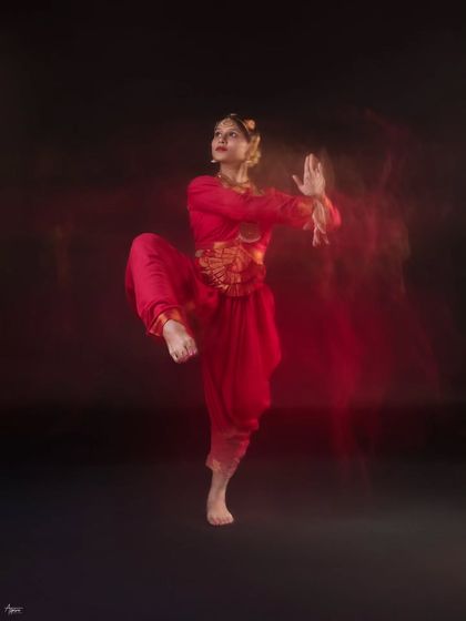 A powerful high-kick pose combined with motion blur. The technique adds a sense of dynamism and energy, making the image feel alive and vibrant.