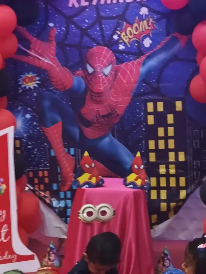 The complete Spiderman first birthday setup, including the themed cake table and 'My 1st Birthday' cutout.