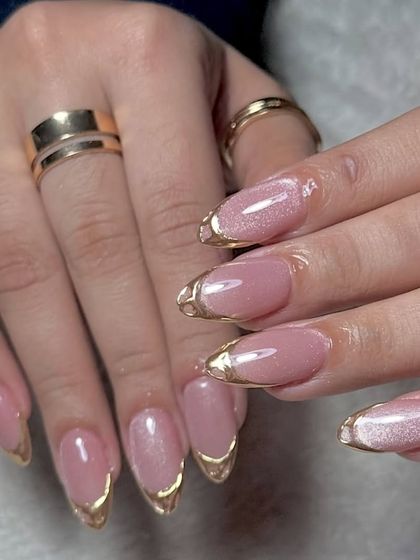 The full set of pink cat eye and gold chrome French nails, a truly luxurious look.