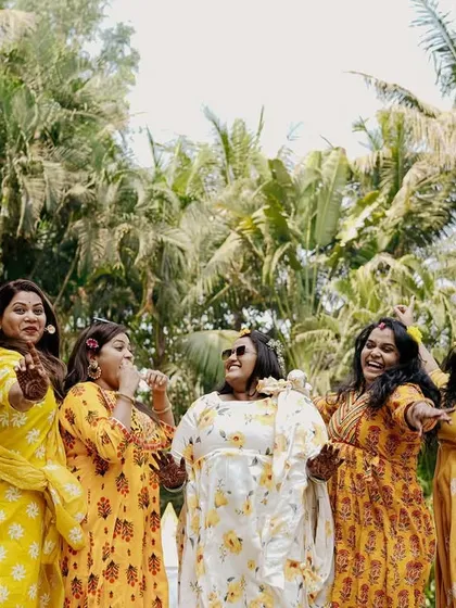 The bride and her bridesmaids having a blast during the Haldi ceremony. Capturing these moments with friends is just as important as the couple shots.