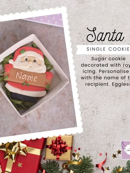 A single Santa cookie, decorated with royal icing and ready to be personalized with the recipient's name. A simple, sweet, and eggless Christmas treat.
