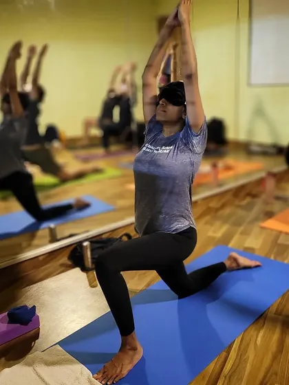 Exploring a deeper sense of awareness in a blindfold yoga class. By removing the sense of sight, students can tune inward, focusing entirely on their breath and body's movements, which enhances concentration and balance.