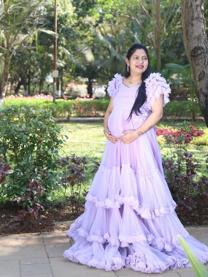 A solo portrait highlighting the intricate ruffled layers of the lavender ball gown. This dress is perfect for creating a dreamy and feminine look in a garden setting.