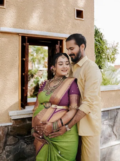 A loving portrait of a couple during their outdoor maternity session. The husband-to-be embraces his wife from behind, both sharing a quiet, happy moment.
