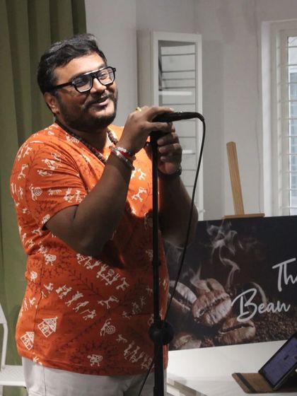 An artist passionately performing at "The Bean Grill" open mic. The simple setup puts the focus right where it belongs: on the talent.