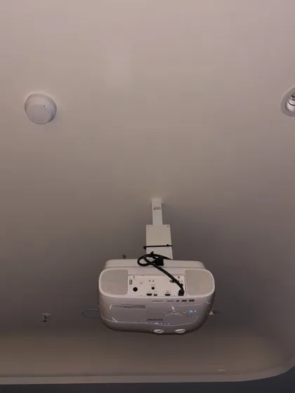 A view of the ceiling-mounted projector, showing the clean wiring and secure bracket. We handle all aspects of the installation to ensure a safe and professional finish.