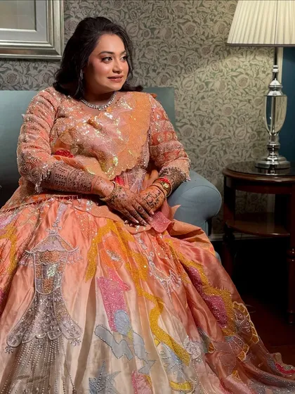 A full-length view of the bride in her unique, artfully designed Sangeet lehenga.