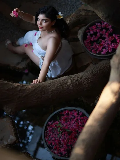 This creative composition uses the environment to frame the model in a unique way. The high-angle perspective and the reflection in the water create a complex and visually interesting image.
