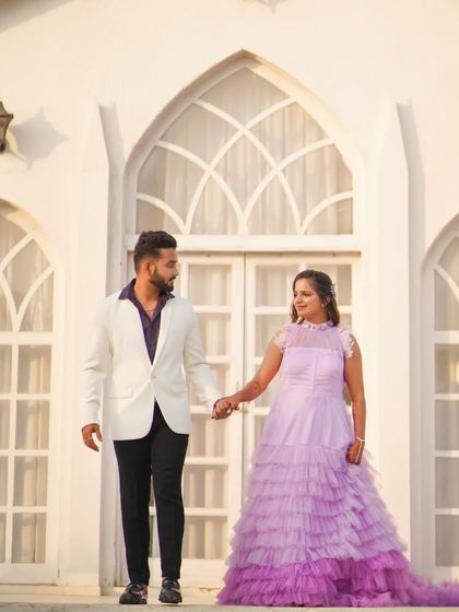 This stunning lavender gown with a long, tiered trail is perfect for couples who want a dramatic pre-wedding shoot. The ombre colour and textured ruffles create incredible movement and visual interest.