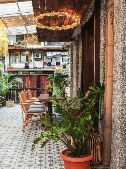 Every corner of the cafe is thoughtfully designed to offer a sense of peace. This is a view of our tranquil outdoor space, ready for you to settle in.