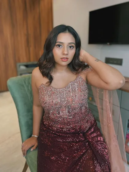 A galaxy-inspired reception look. The ombre sequin gown is complemented by a soft, shimmery eye and glowing skin, creating a celestial vibe.