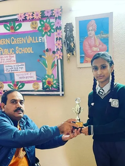 The principal of Modern Green Valley Public School awarding a trophy to one of our champions.