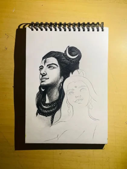A work-in-progress shot of a Shiv Parvati sketch. Lord Shiva's face is complete, while Mata Parvati's outline awaits the details. This shows the step-by-step process.