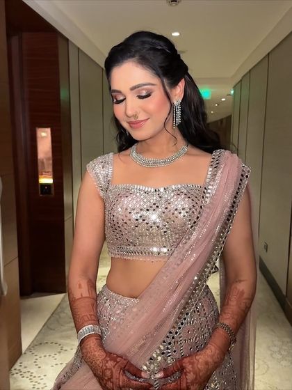 A beautiful candid moment. The makeup looks soft and radiant, even with her eyes closed, showcasing the quality of the application.