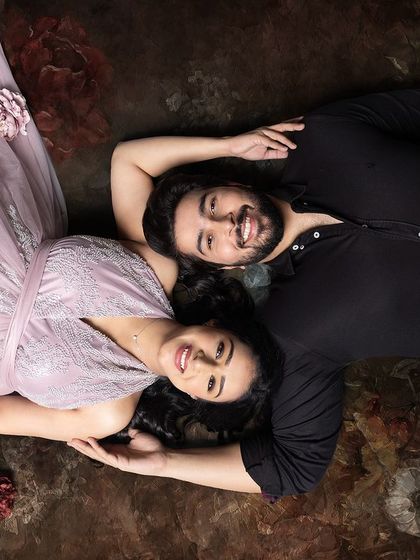 Some images stay in your heart forever. This creative, top-down shot of a couple lying on a floral background is a beautiful and artistic way to capture their love.