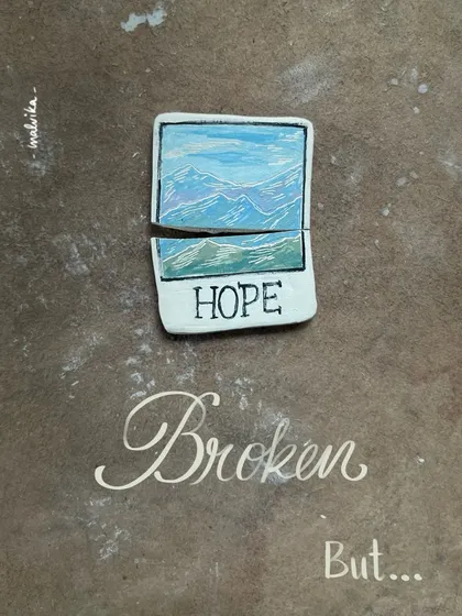 In pottery, things break. It’s a part of the process. This piece, a small ceramic polaroid with a mountain view, cracked right in half. It’s a lesson in learning to let go of perfection.