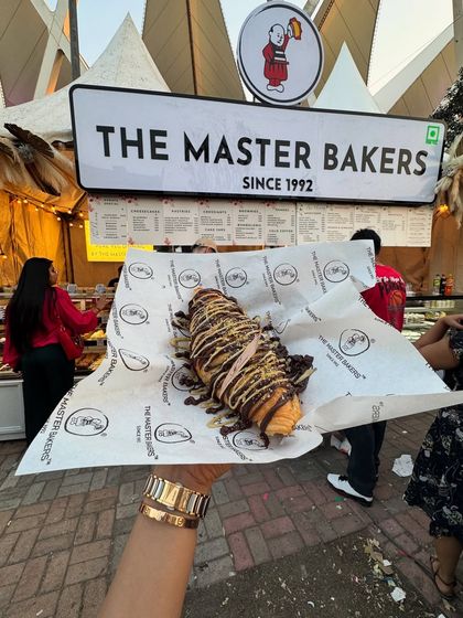 Our Kunafa Croissant, seen here at the Horn OK Please festival, is a star. Held up against the backdrop of our bustling stall, you can see the generous layers of chocolate and pistachio that make it so irresistible.