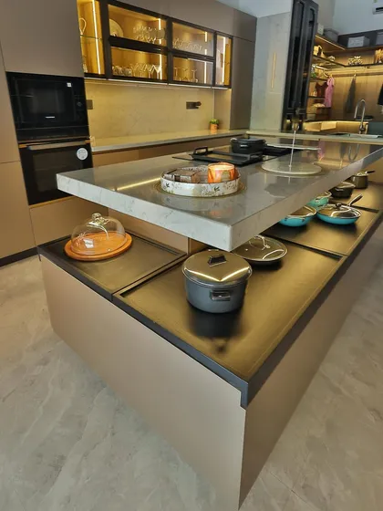 This image highlights the innovative two-tiered island, which provides both a workspace and lower-level storage for pots and pans. It’s a smart solution for maximizing functionality in a compact area.