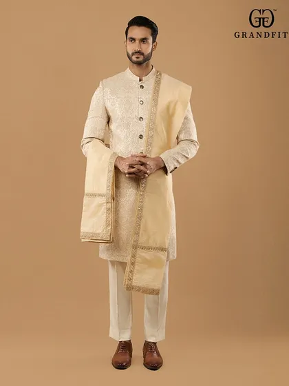 A complete, immaculately curated wedding look. We design every element of the groom's attire, including complementary stoles and accessories, to create a cohesive and distinguished presence.