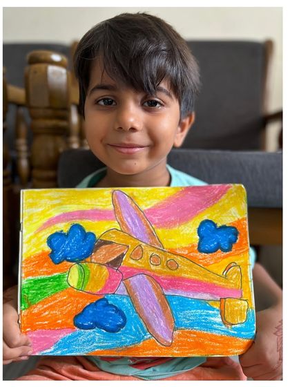 Another first-grader with his fantastic airplane drawing. It's always exciting to see how different students interpret the same subject with their own unique flair.