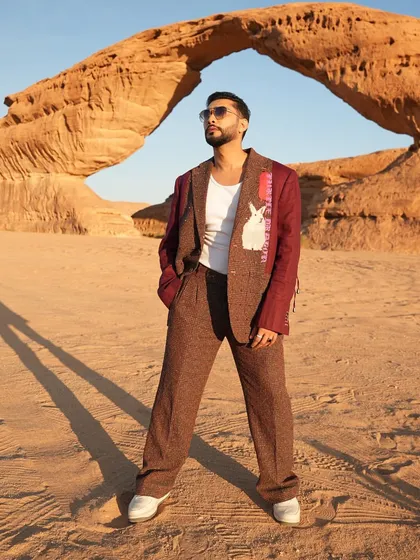 The full silhouette of Zaid Darbar's suit, showing the wide-leg trousers and relaxed fit. It's a contemporary take on tailoring that prioritizes both style and comfort.