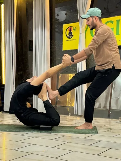"Wapas nahi aana hai!" (Don't come back!) My Guru would shout this as I held a difficult pose. His intensity taught me to push beyond my perceived limits, like in this deep assisted Dhanurasana (Bow Pose).
