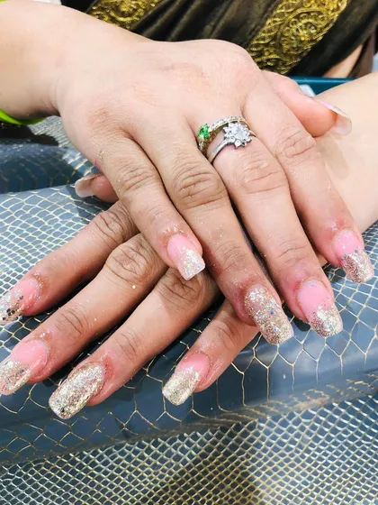 A classic glitter fade with a gold sparkle over a natural pink base.