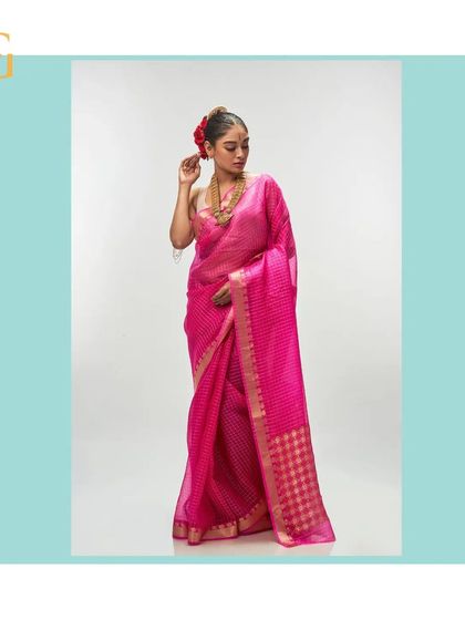 Another look at the vivid cerise saree, highlighting the fine gold zari checks.