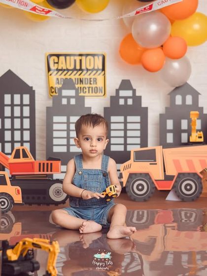 Caution, cutie under construction. This creative construction zone theme is filled with toy trucks, traffic signs, and a city skyline for a busy little builder.