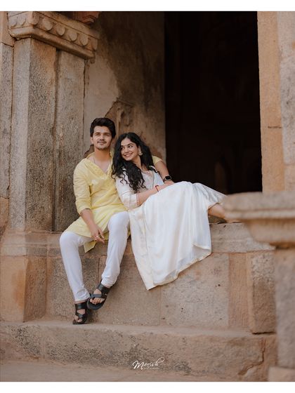 A quiet moment of togetherness on ancient stone steps. This portrait from their pre-wedding shoot has a timeless, storybook quality.