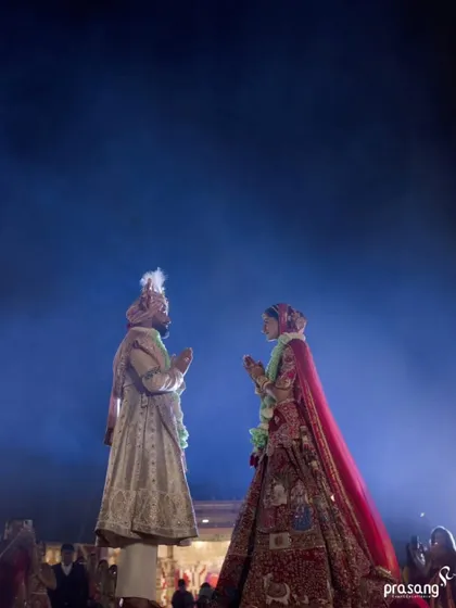 The varmala exchange is the first step in the union. I stage this moment on an elevated platform with dramatic backlighting to create a divine, larger-than-life silhouette, symbolizing the significance of this sacred ritual.