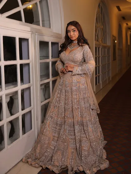 This shot in a hallway showcases the grand trail and beautiful fall of our silver-grey lehenga. It’s designed to make you feel like you are on a red carpet.