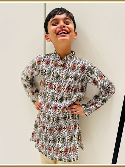 This little cutie is rocking our printed kurta like a pro. His infectious laugh shows just how much he loves his comfortable and stylish festive outfit.