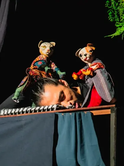 The mischievous cat and dog puppets play on their sleeping owner in 'Hiss & Arf', a perfect example of the show's wit and physical comedy.