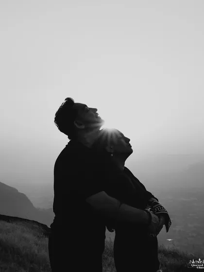 Sometimes, the most powerful moments are the quietest. This black and white silhouette, captured during the golden hour in the hills of Nashik, focuses purely on the connection and shared peace between two people, bathed in soft, natural light.