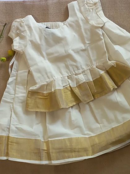 For our Vishu and Onam collection, I created this classic Kasavu on Kasavu paavada blouse. The peplum style top adds a modern touch to the traditional off-white and gold cotton fabric, perfect for celebrating southern festivals.