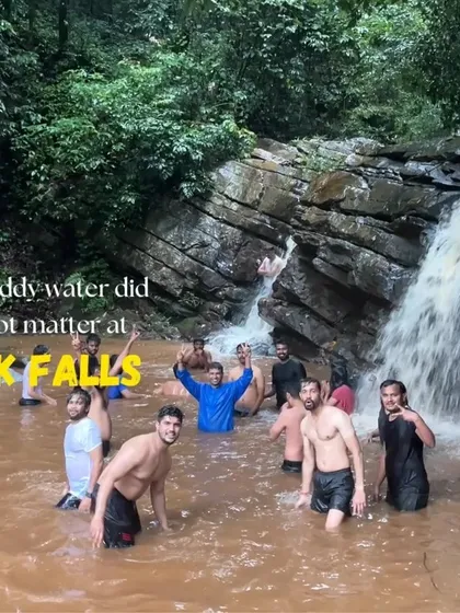 Even muddy water doesn't stop the fun at the waterfalls near Kudremukha.