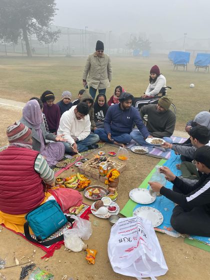 A wider view of our New Year Hawan Pooja. The entire team, including our para-archers, sits together to share in the ceremony and prasad, reinforcing our community bond.