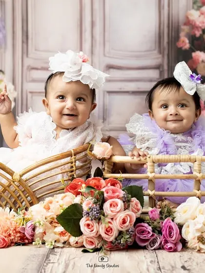 We captured the pure joy of these twin sisters interacting during their studio photoshoot. Our team is experienced in working with multiples to create beautiful, coordinated portraits.