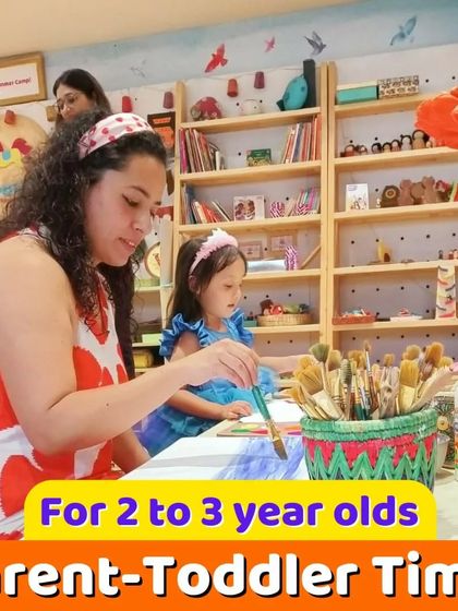 A parent and toddler painting together, a perfect example of our bonding-focused activities.