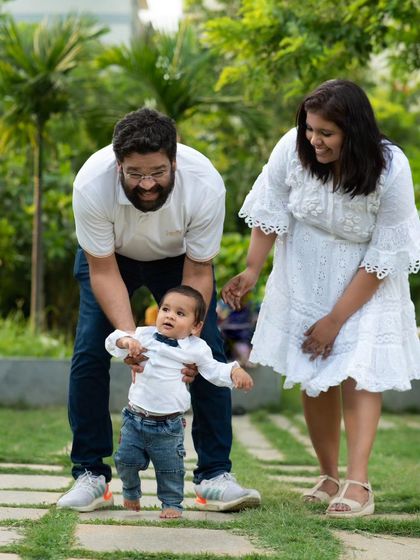 A slightly different angle from the same outdoor session, this image captures the pure delight on the parents' faces. It shows how I work to get a variety of shots that tell the complete story of your family's interaction during the photoshoot.