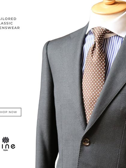 A mannequin displaying a perfectly tailored grey suit with a polka-dot tie and pocket square. This shows our commitment to classic, coordinated style.