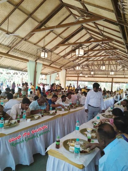 Guests seated for a traditional meal at an outdoor event. We are experienced in managing catering for both indoor and outdoor functions.