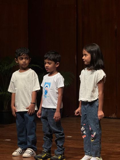 A trio of young actors completely focused and in character during their scene.