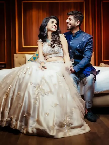 A romantic indoor portrait of the couple, with warm, ambient lighting.