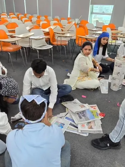 Teams deep in concentration during a creative construction challenge. We use hands-on activities like this to break down departmental silos and encourage members from finance, HR, and media to collaborate in new ways.