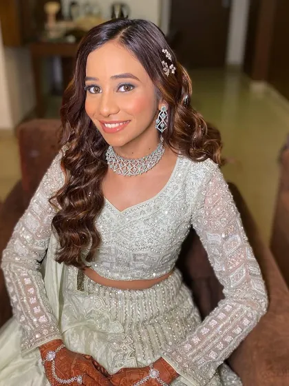 The bride looking absolutely radiant. This look is perfect for an engagement or Sangeet, offering a balance of glamour and elegance.