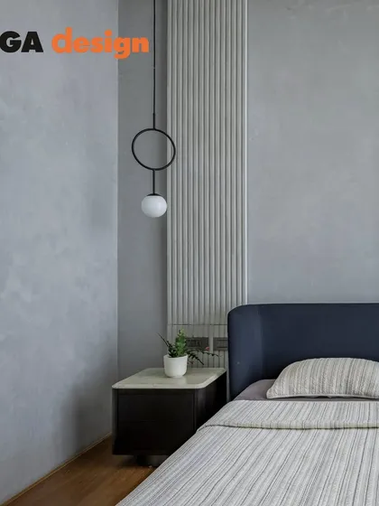 A close-up of the bedside in the minimalist master bedroom, highlighting the clean lines of the furniture and the simple yet elegant pendant light.